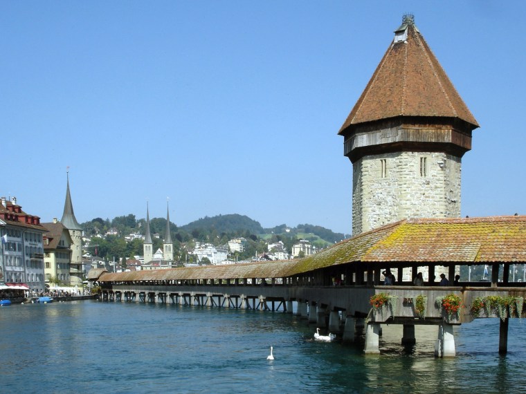 Luzern's Reuss River is spanned by the wooden Chapel Bridge, with its iconic stone water tower.